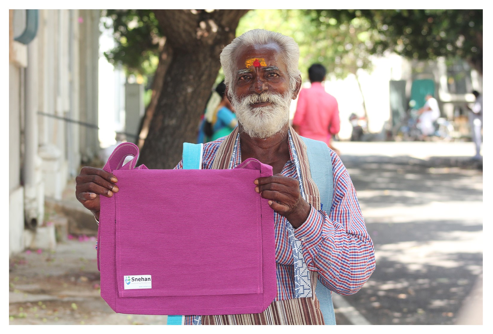 A Snehan beneficiary selling a handmade cotton bag